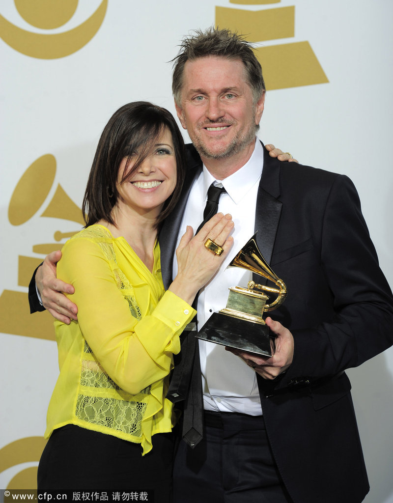 Gordon Goodwin, right, and Lisa Gordon pose backstage with the award for best instrumental arrangement for 'Rhapsody in Blue' at the 54th annual Grammy Awards on Sunday, Feb. 12, 2012 in Los Angeles.