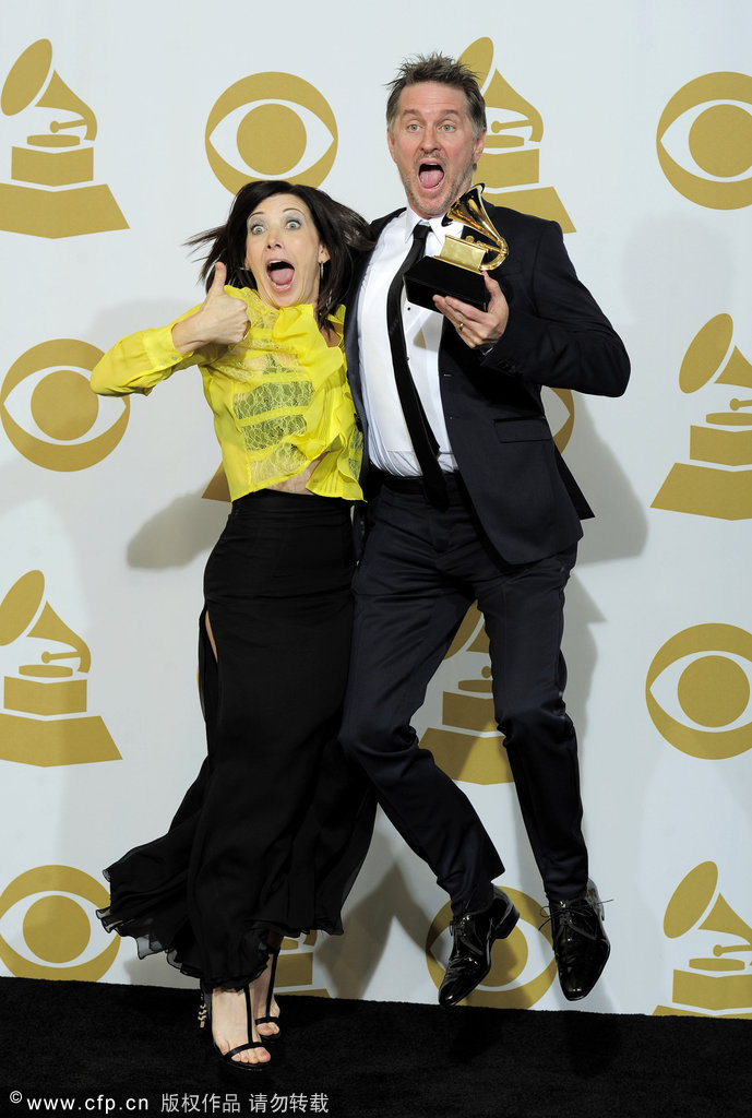 Gordon Goodwin, right, and Lisa Gordon pose backstage with the award for best instrumental arrangement for 'Rhapsody in Blue' at the 54th annual Grammy Awards on Sunday, Feb. 12, 2012 in Los Angeles.