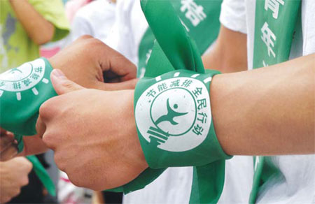 Volunteers wearing wrist bands supporting a global campaign for energy conservation. According to a recent survey jointly conducted by Tsinghua University and public relations firm Ruder Finn, 92.1 percent of consumer respondents say they are concerned about corporate social responsibility in the automobile industry, a figure much higher than in other industries. [China Daily] 