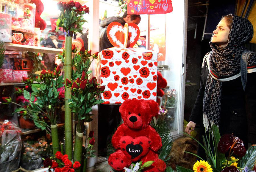 An Iranian woman chooses a gift for the Valentine's Day at a store in Tehran, Iran, Feb. 13, 2012. [Xinhua photo]