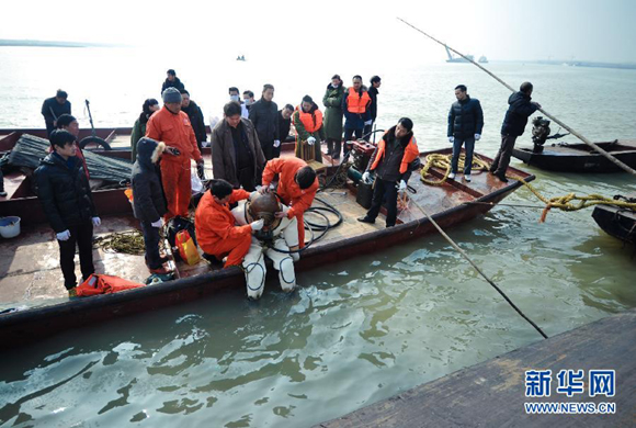 Ten bodies have been retrieved and one person remains missing nearly two weeks after a boat capsized in central China's Hunan Province. In this photo taken on Feb. 3, a diver is ready for searching the missing people.