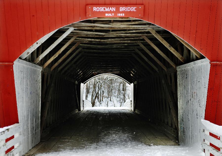 The Roseman Covered Bridge is covered with snow in Winterset, Iowa, the United States, Feb. 13, 2012. More than a decade after the movie 'The Bridges of Madison County' was released, thousands of people still travel to Winterset each year to trace the steps where Clint Eastwood and Meryl Streep immortalized the area's covered bridges. 