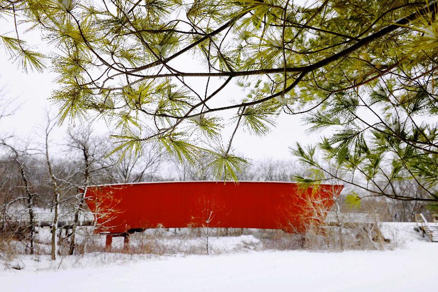 The Roseman Covered Bridge is covered with snow in Winterset, Iowa, the United States, Feb. 13, 2012. More than a decade after the movie 'The Bridges of Madison County' was released, thousands of people still travel to Winterset each year to trace the steps where Clint Eastwood and Meryl Streep immortalized the area's covered bridges. 