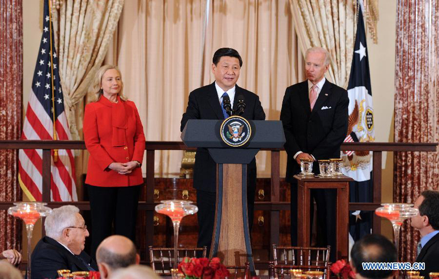 Chinese Vice President Xi Jinping (C) addresses a luncheon jointly hosted by his U.S. counterpart Joe Biden (R) and U.S. Secretary of State Hillary Clinton in Washington, the United States, Feb. 14, 2012.