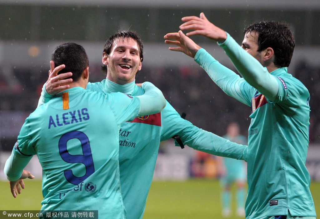 Barcelona's Alexis Sanschez (L-R), Lionel Messi and Cesc Fabregas celebrate after scoring the 1:0 during the Champions League round of 16 first leg soccer match between Bayer Leverkusen and FC Barcelona at the BayArena in Leverkusen, Germany on February 14, 2012.