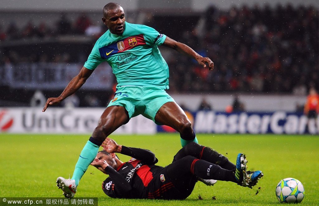 Renato Augusto of Leverkusen challenges Eric Abidal of Barcelona during the UEFA Champions League round of 16 first leg match between Bayer 04 Leverkusen and FC Barcelona at BayArena on February 14, 2012 in Leverkusen, Germany.