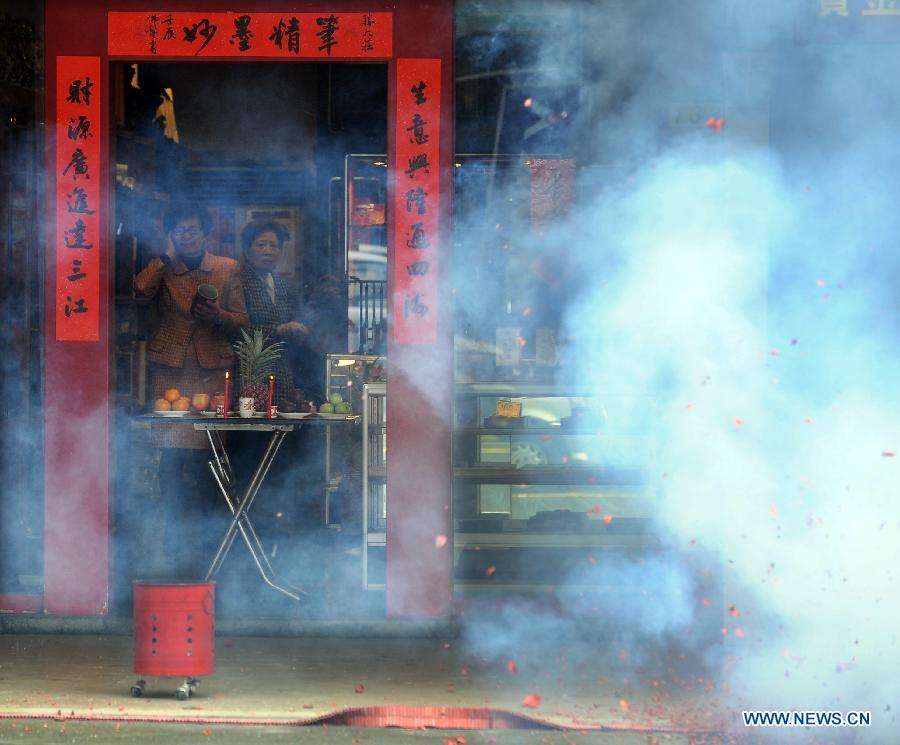 People set fireworks to pray for a good fortune in the new year in Taipei, southeast China's Taiwan, Jan. 27. 2012. Various celebrations were held on the fifth day of the Chinese lunar New Year, which is considered as the birthday of the 'God of Wealth' in Chinese tradition.