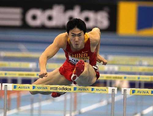 Liu Xiang of China crosses a hurdle during the men's 60m hurdles final at the Birmingham indoor tournament in Birmingham, Feb. 18, 2012. Liu Xiang wins the men's 60m hurdles final at the Birmingham indoor tournament on Saturday. (Xinhua/Yin Gang)