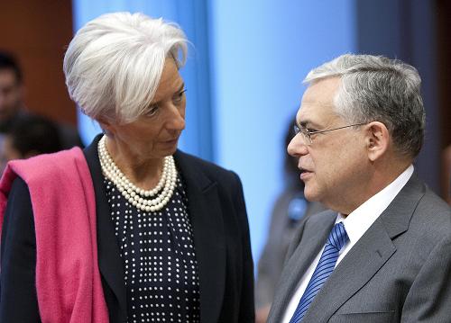 Christine Lagarde(L), Managing Director of the International Monetary Fund talked with Greek Prime Minister Lucas Papademos at the Eurozone finance ministers meeting in Brussells on Feb 20, 2012