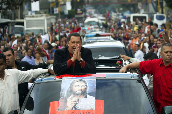 Venezuelan President Hugo Chavez is greeted by supporters on his way to the airport to travel to Cuba, in Caracas on February on 24, 2012. Chavez travels to Cuba on Friday for treatment of what he says is likely a malignant tumor as the leftist president faces a renewed cancer scare ahead of a tough reelection battle. [AFP/Xinhua]