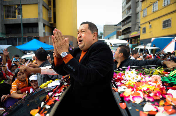 Venezuelan President Hugo Chavez (C) is greeted by supporters on his way to the airport to travel to Cuba, in Caracas on February on 24, 2012. Chavez travels to Cuba on Friday for treatment of what he says is likely a malignant tumor as the leftist president faces a renewed cancer scare ahead of a tough reelection battle. [AFP/Xinhua]