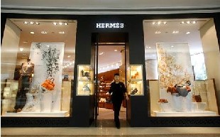 A clerk walks out of a Hermes store. [File photo]