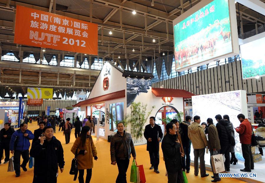 Visitors tour the Nanjing Travel Fair 2012 at the International Expo Center in Nanjing, capital of east China's Jiangsu Province, Feb. 24, 2012. Opening here on Friday, the three-day event displayed tourist products brought by 190 exhibitors from 25 countries and regions. 