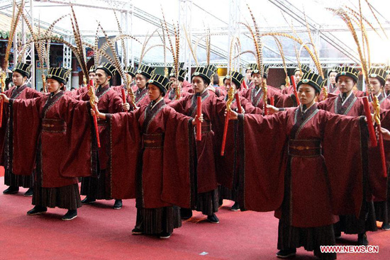 Performers take part in the spring sacrificing ceremony of the Confucius Temple in Taipei, southeast China's Taiwan, Feb. 26, 2012. Nearly 1,000 people attended the ancient-style ceremony, which is held annually to encourage students to set clear goals and study hard in the beginning of a year. (Xinhua/Gao Xueyu)