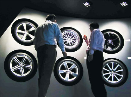Visitors at a tire booth at an international auto exhibition in Shanghai. A number of Chinese exports, including tires, have become the subject of EU anti-dumping and anti-subsidy rulings, and industry experts said there may be more such cases in the future.[China Daily]