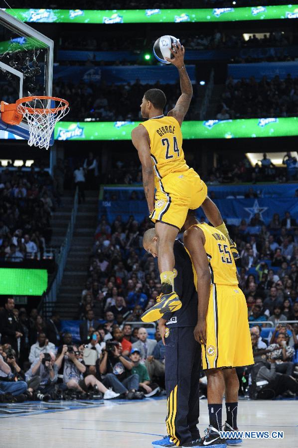 Indiana Pacers' Paul George (Top) dunks during the Sprite Slam Dunk Contest part of 2012 NBA All-Star Weekend in Orlando, the United States, Feb. 25, 2012. (Xinhua/Zhang Jun) 