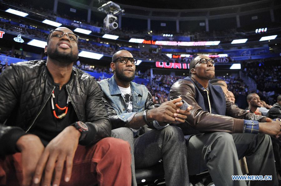 Miami Heat's Dwyane Wade(L), Lebron James(C) and Dwight Howard of Orlando Magic watch the Three-Point Contest part of 2012 NBA All-Star Weekend in Orlando, the United States, Feb. 25, 2012. (Xinhua/Zhang Jun) 