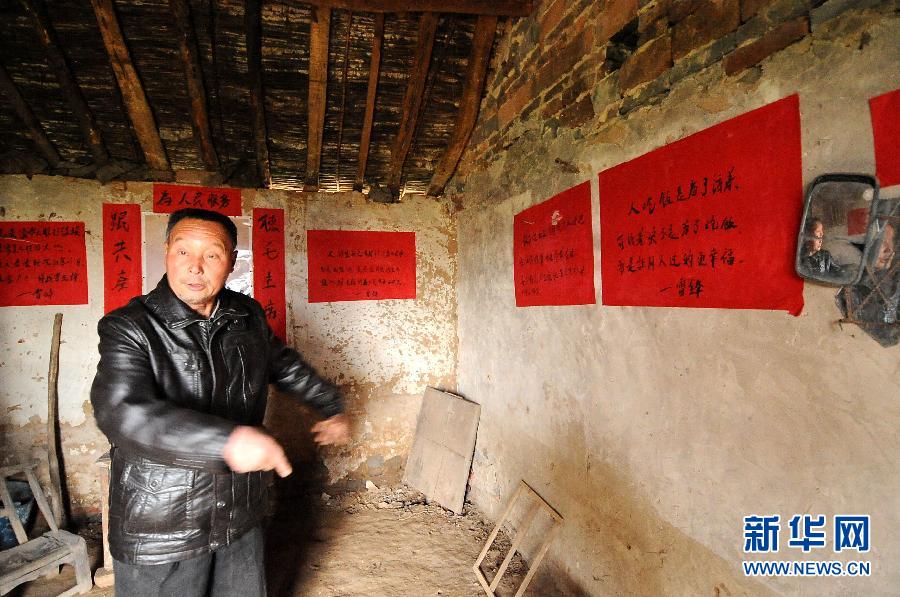 Slogans commemorating Lei Feng on a wall at a resident's house in Dengzhou City, Henan Province, on Feb.21, 2012.