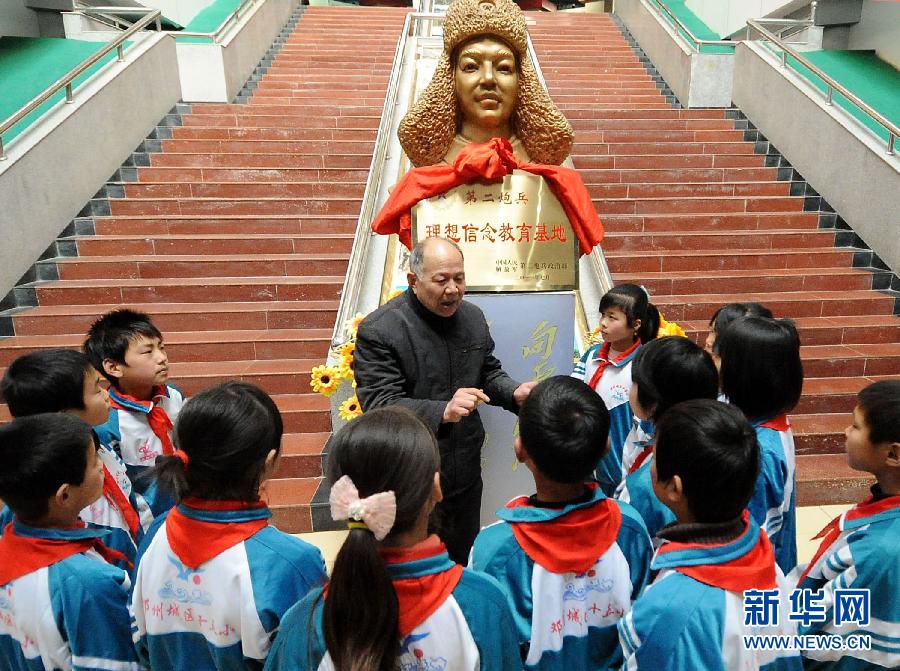Song Qingmei, head of the 'Supernumerary Lei Feng group', tells stories about Lei Feng in Dengzhou City, Henan Province, on Feb.21, 2012. 