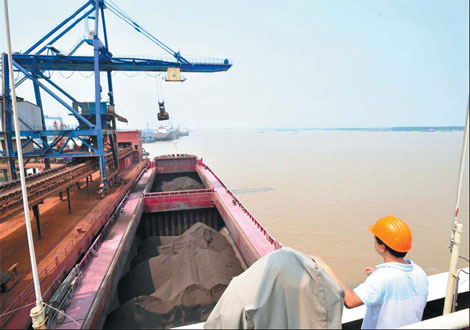 Iron concentrate from Brazil arrives at the port of Ningbo city, Zhejiang province. Officials say that as the effects of China's macroeconomic regulations and control measures continue to be felt, it's possible that iron ore prices could fall further.[China Daily]
