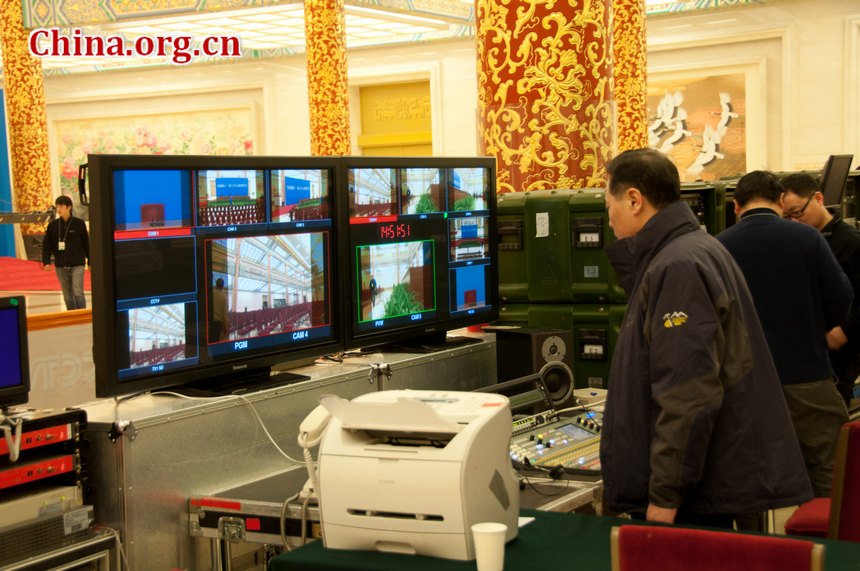 TV screws make final checks to monitors and other equipments at the Golden Hall in the Great Hall of the People in Beijing, China, on the afternoon of Thursday, March 1, 2012, one day before the press conference of Chinese People&apos;s Political Consultative Conference (CPPCC) scheduled on Friday afternoon, March 2, 2012. [China.org.cn]