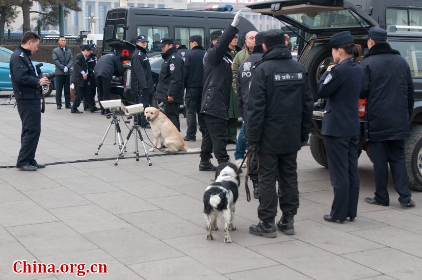 Police officers check the journalists&apos; vehicles as they enter a special parking section in Tian&apos;anmen Square before the openining ceremony of CPPCC opens on Saturday afternoon at the Great Hall of the People in Beijing, China. [China.org.cn]