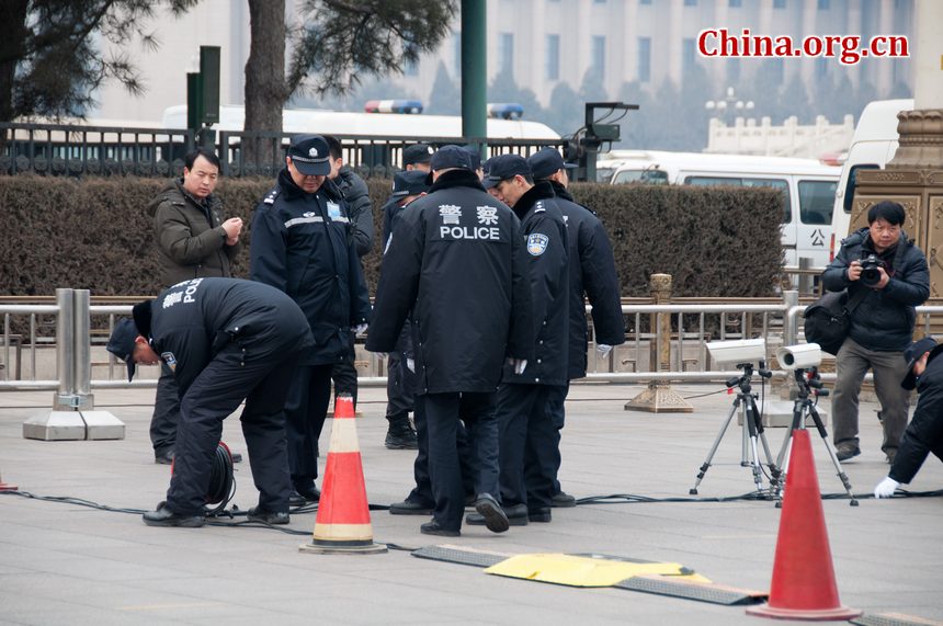 Police set up surveillance cameras on the path leading to the parking area for journalists&apos; vehicles shortly before the CPPCC opens its annual session at the Great Hall of the People in Beijing on Saturday afternoon. [China.org.cn]