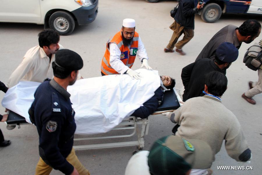 Rescuers transfer an injured policeman to a hospital in northwest Pakistan's Peshawar on March 3, 2012. At least one policeman was killed and eight other people including two cops injured in a suicide bomb attack that hit Pakistan's northwestern city of Charsadda, which near Peshawar on Saturday afternoon, according to local police and officials.(Xinhua/Umar Qayyum