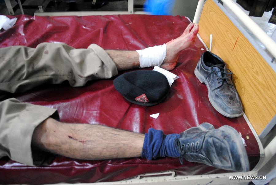 An injured policeman receives medical treatment at a hospital in northwest Pakistan's Peshawar on March 3, 2012. 