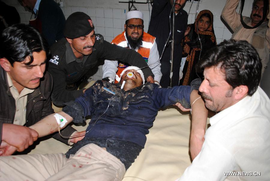 An injured man receives medical treatment at a hospital in northwest Pakistan's Peshawar on March 3, 2012. 