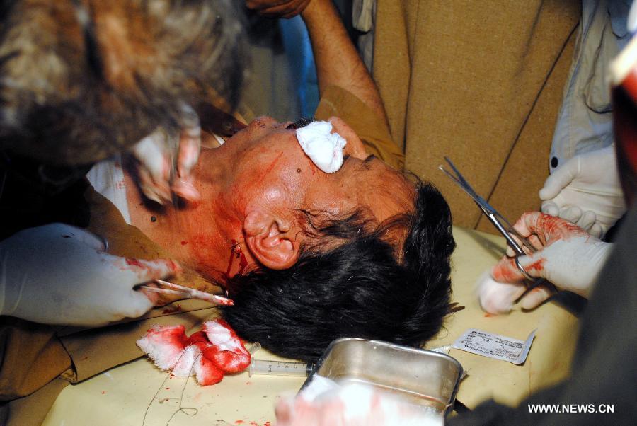 An injured man receives medical treatment at a hospital in northwest Pakistan's Peshawar on March 3, 2012. 