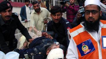 Rescuers transfer an injured policeman to a hospital in northwest Pakistan's Peshawar on March 3, 2012. 