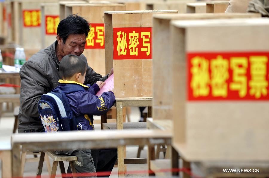 Thousands of people in south China's village of Wukan went to polls Saturday to elect a new village committee, several months after staging massive protests over illegal land sales and other issues. 