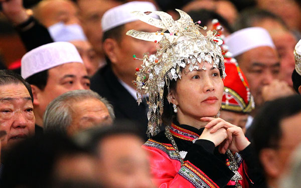 An ethnic group member of the Chinese People's Political Consultative Conference National Committee listens attentively to the opening speeches in Beijing, March 3, 2011. [Photo by Zou Hong/China Daily] 