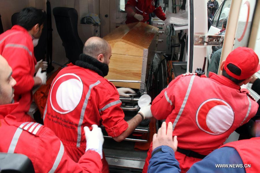 The coffin of American reporter Marie Colvin is carried into an ambulance at al- Assad Hospital in Damascus, Syria, March 3, 2012. The bodies of two foreign journalists who were killed last week in Syria's restive Homs province were handed over to representatives of their countries Saturday. (Xinhua/Hazim) 