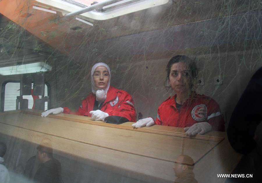 The Syrian Red Crescent officials carry the coffin of French photographer Remi Ochlik at al-Assad Hospital in Damascus, Syria, March 3, 2012. The bodies of two foreign journalists who were killed last week in Syria's restive Homs province were handed over to representatives of their countries Saturday. (Xinhua/Hazim) 