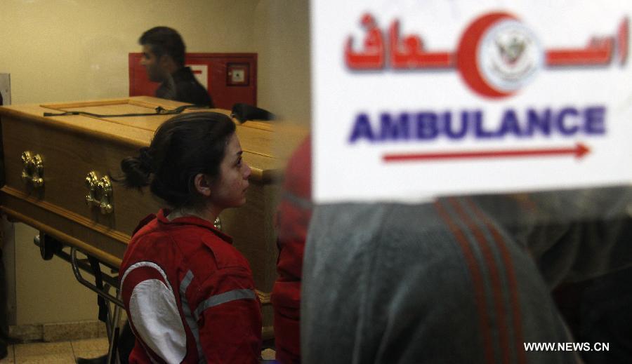 The Syrian Red Crescent officials carry the coffin of French photographer Remi Ochlik into an ambulance at al- Assad Hospital in Damascus, Syria, March 3, 2012. The bodies of two foreign journalists who were killed last week in Syria's restive Homs province were handed over to representatives of their countries Saturday. (Xinhua/Hazim) 