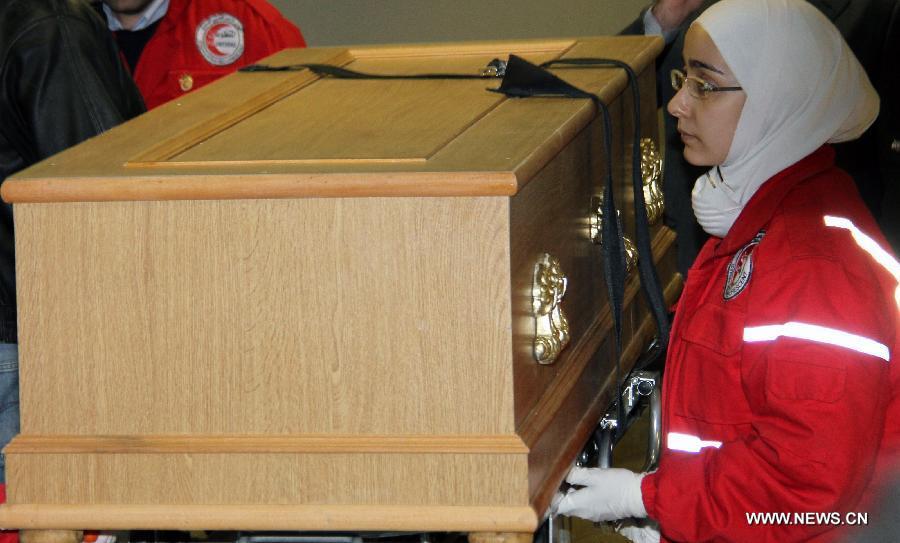 The Syrian Red Crescent officials carry the coffin of French photographer Remi Ochlik at al-Assad Hospital in Damascus, Syria, March 3, 2012. The bodies of two foreign journalists who were killed last week in Syria's restive Homs province were handed over to representatives of their countries Saturday. (Xinhua/Hazim) 