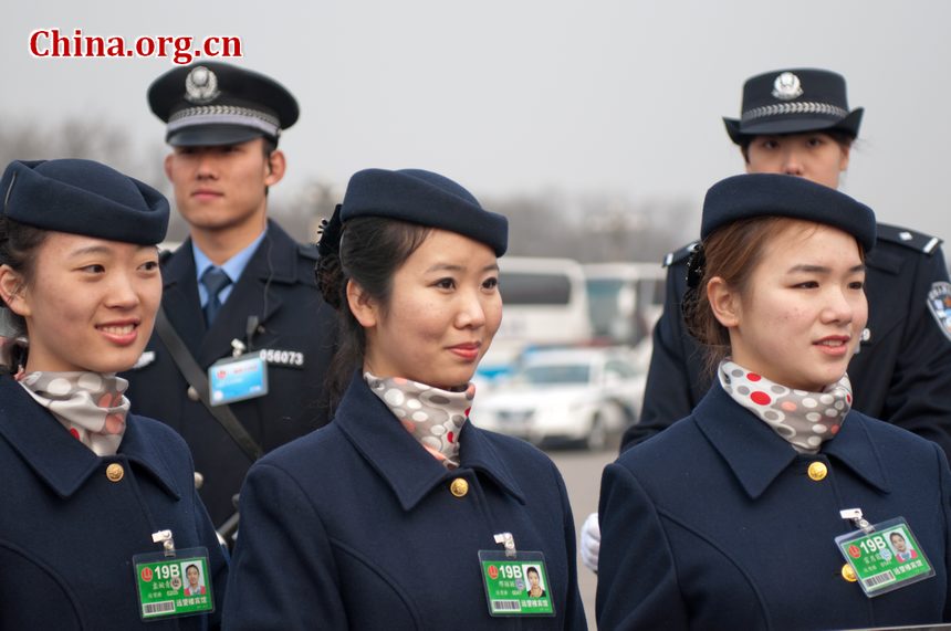 Hotel staff members serving the delegations to the National People's Congress (NPC) pose for photos at the Tian'anmen Square on Sunday, March 4, 2012, in Beijing, China, one day prior to the NPC's opening ceremony on the morning of March 5 at the Great Hall of the People. [China.org.cn]