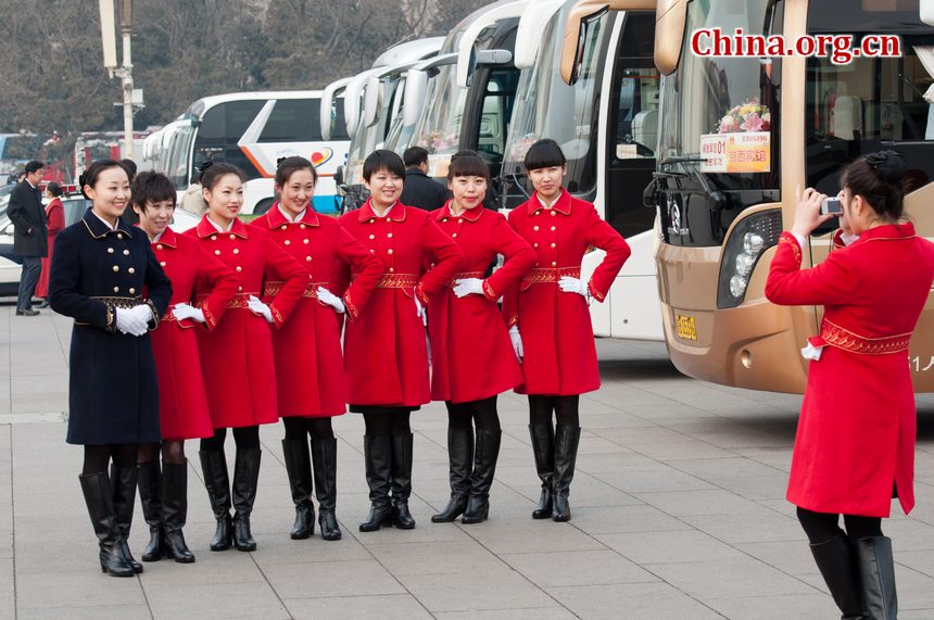 Hotel staff members serving the delegations to the National People's Congress (NPC) pose for photos at the Tian'anmen Square on Sunday, March 4, 2012, in Beijing, China, one day prior to the NPC's opening ceremony on the morning of March 5 at the Great Hall of the People. [China.org.cn]