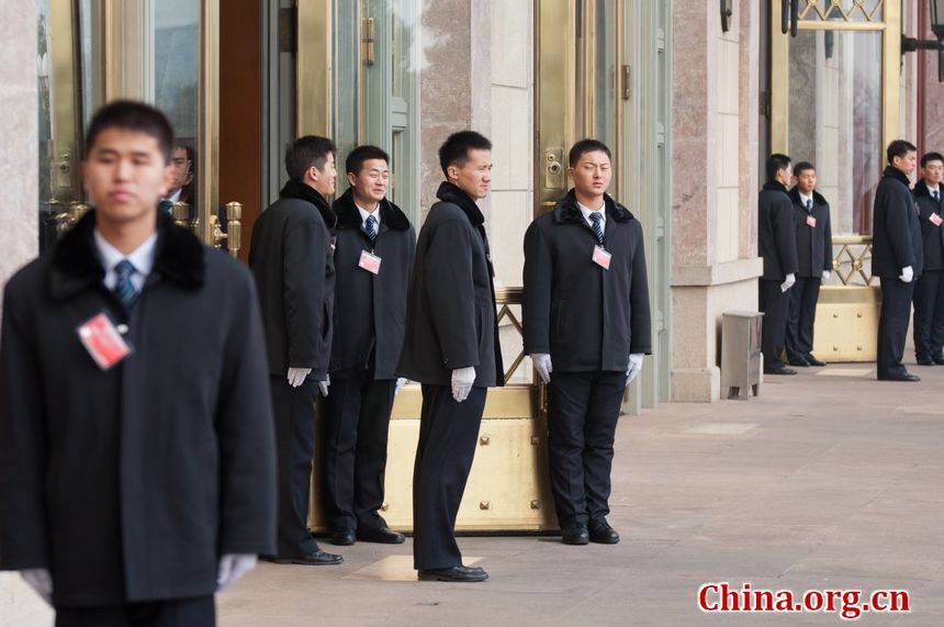 Security staff members line up at the entrance to the Great Hall of the People in Beijing, China, on Sunday, March 4, 2012 as delegates to the congress and journalists covering the events queue to enter the venue. [China.org.cn]