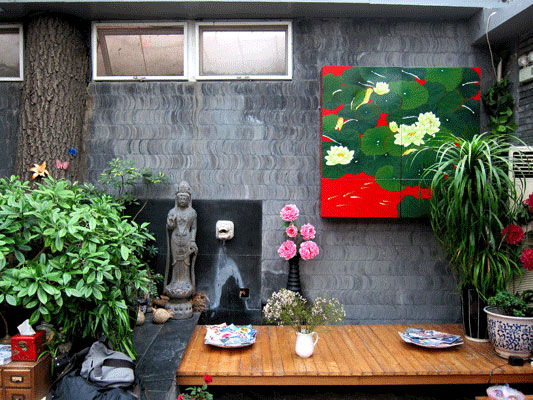 A 100 year old tree, built into Kelly's courtyard wall. Photo by CRI's William Wang, taken February, 2012.