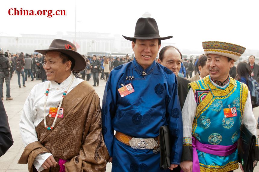 Delegates from China&apos;s ethnic groups beam beam at the lens and pose for photos as they walk into the Great Hall of the People to attend the opening ceremony of the Fifth Session of the 11th National People&apos;s Congress (NPC) on Monday, March 5, in Beijing, China. [China.org.cn]