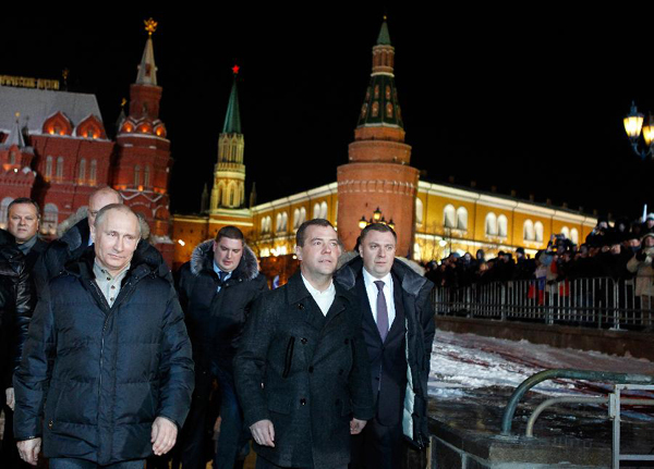Russian President Dmitry Medvedev (2nd L) walks with Russia's presidential candidate and incumbent Prime Minister Vladimir Putin (1st L) as they attend a gathering in Moscow, March 4, 2012. [Xinhua/RIA Novosti] 