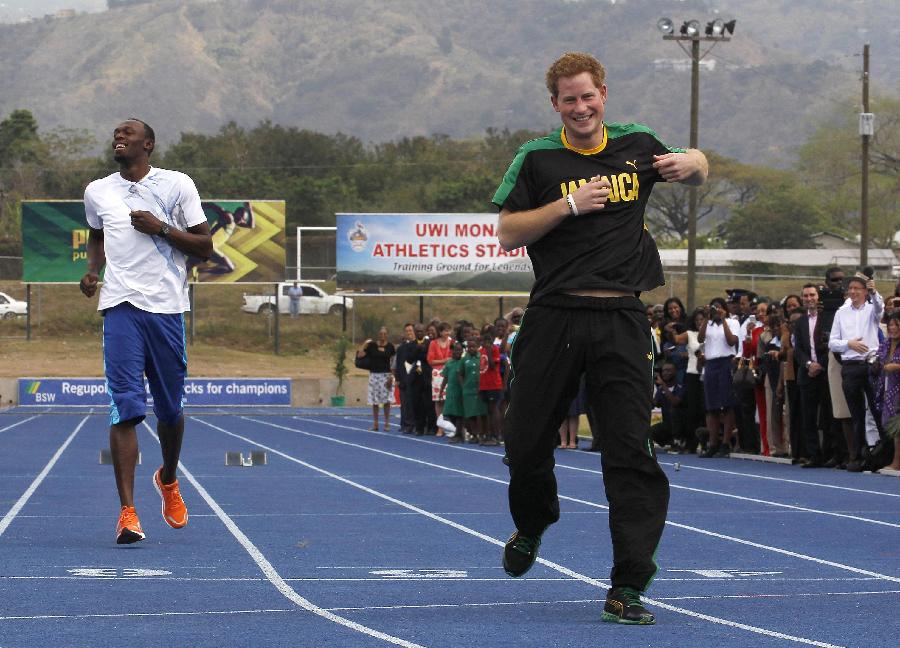 Britain's Prince Harry (R) and Olympic gold medallist Usain Bolt run a race at the Usain Bolt track at the University of the West Indies in Kingston, Jamaica on March 6, 2012.