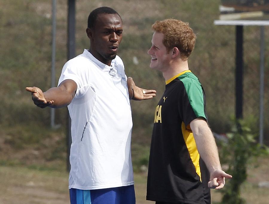 Britain's Prince Harry (R) and Olympic gold medallist Usain Bolt joke during his visit to the Usain Bolt track at the University of the West Indies in Kingston, Jamaica March 6, 2012. 