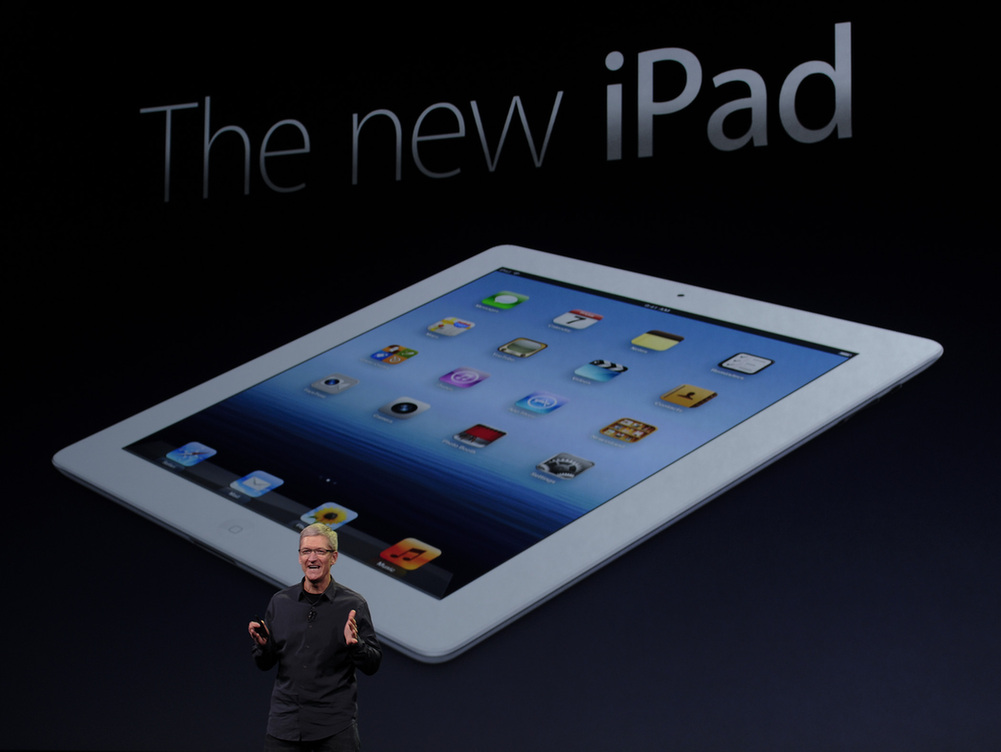 Apple CEO Tim Cook speaks during an Apple event as he introduces the new iPad as an image the device is projected on screen in San Francisco, California March 7, 2012. [Xinhua] 