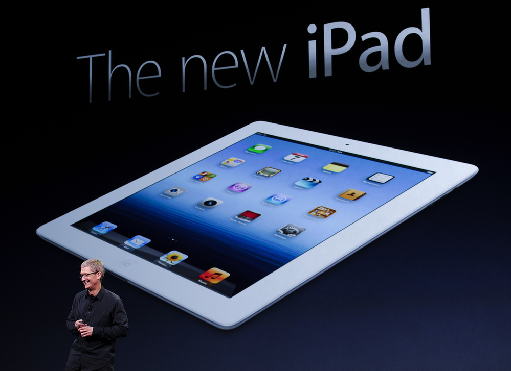 Apple CEO Tim Cook speaks during an Apple event as he introduces the new iPad as an image the device is projected on screen in San Francisco, California March 7, 2012. [Xinhua] 