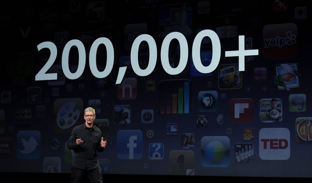 Apple CEO Tim Cook speaks during an Apple event as he introduces the new iPad as an image the device is projected on screen in San Francisco, California March 7, 2012. [Xinhua] 