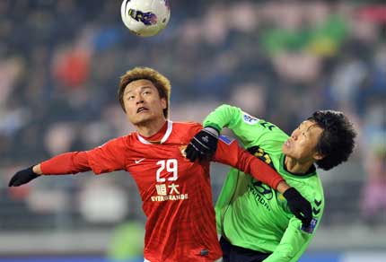 China's Guangzhou Evergrande forward Gao Lin (left) vies for the ball with South Korea's Jeonbuk Hyundai Motors defender Park Won-jae (right) during their Group H AFC Champions League in Jeonju ,South Korea.